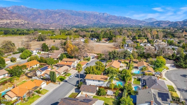 birds eye view of property with a mountain view