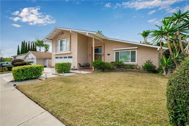 view of front of house with a garage and a front lawn