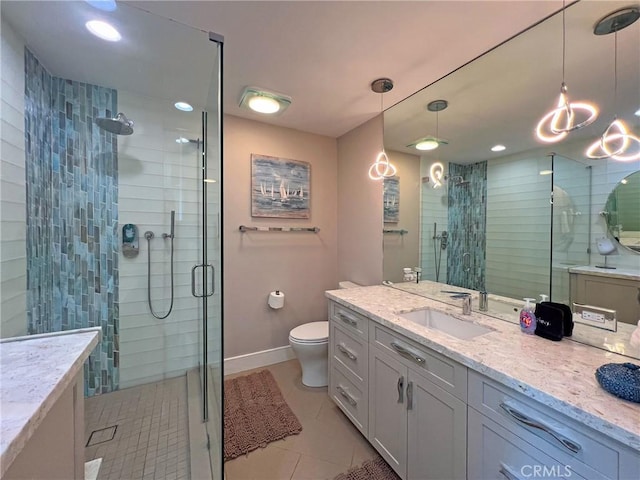 bathroom with vanity, tile patterned flooring, toilet, and walk in shower