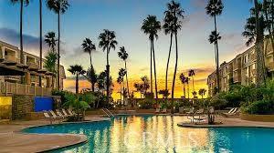 pool at dusk featuring a patio area