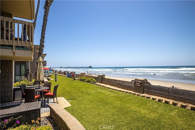 view of yard featuring a water view and a view of the beach