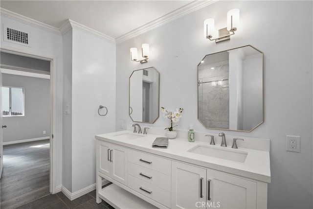 full bath with a sink, visible vents, double vanity, and crown molding