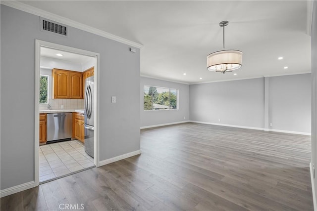 interior space with baseboards, visible vents, recessed lighting, crown molding, and light wood-type flooring