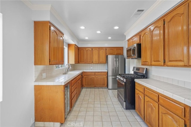 kitchen with visible vents, ornamental molding, decorative backsplash, brown cabinetry, and stainless steel appliances