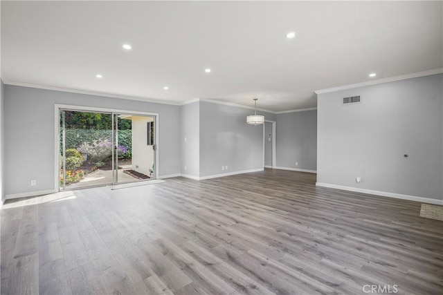 empty room featuring recessed lighting, wood finished floors, visible vents, and baseboards