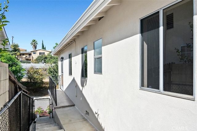 view of home's exterior featuring fence and stucco siding