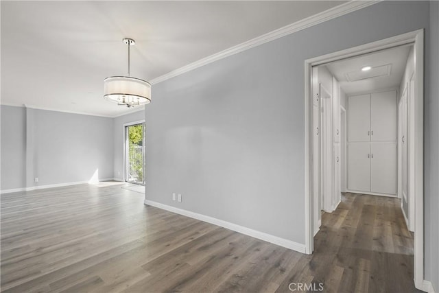 interior space with baseboards, wood finished floors, and ornamental molding