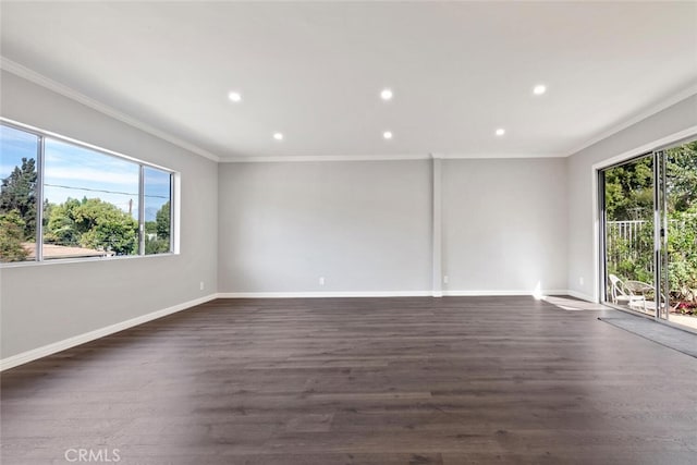 unfurnished room with dark wood-style floors, crown molding, and baseboards