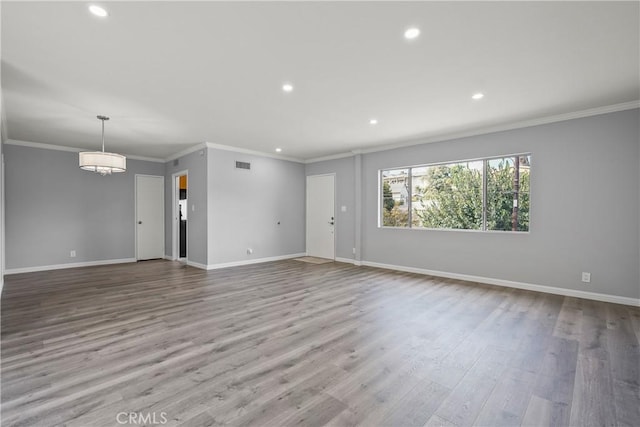 unfurnished living room featuring recessed lighting, visible vents, baseboards, light wood-style floors, and crown molding