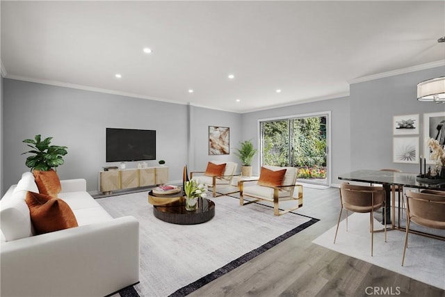 living room with recessed lighting, crown molding, and wood finished floors