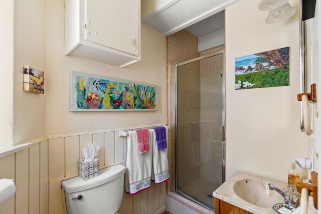 bathroom with vanity, an enclosed shower, and toilet