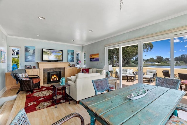 interior space featuring crown molding, a fireplace, and light hardwood / wood-style floors