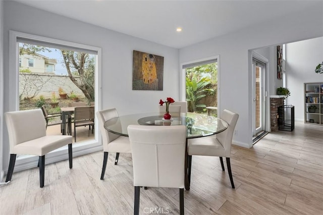 dining room featuring light wood-style floors, a wealth of natural light, and recessed lighting