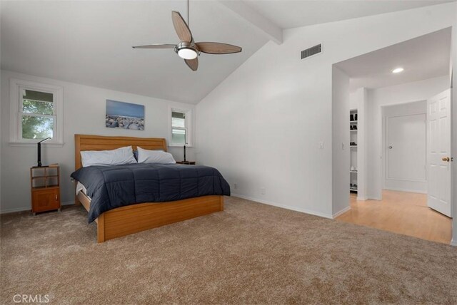 bedroom with vaulted ceiling with beams, light colored carpet, and ceiling fan