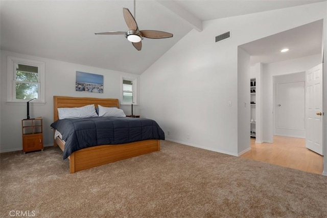 bedroom featuring light carpet, baseboards, visible vents, ceiling fan, and vaulted ceiling with beams