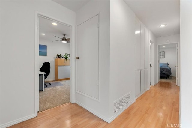 corridor with visible vents, wood finished floors, and recessed lighting