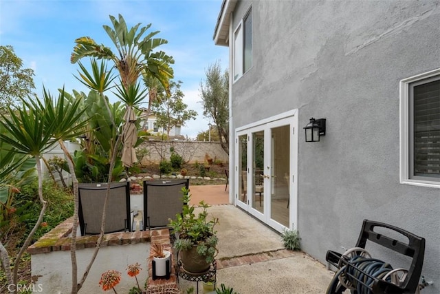 view of patio featuring french doors and a fenced backyard