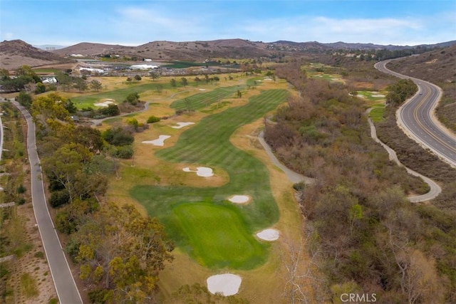 birds eye view of property featuring view of golf course and a mountain view