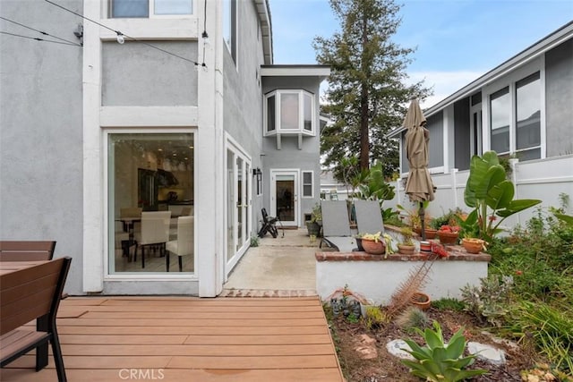 exterior space with a patio area and stucco siding