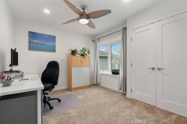 office space featuring light carpet, recessed lighting, a ceiling fan, and baseboards