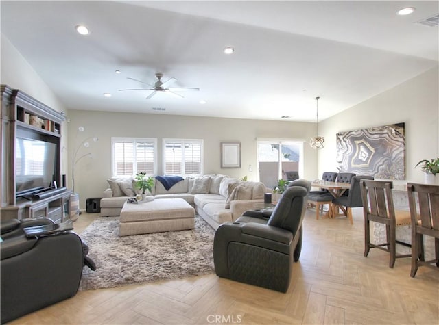 living room featuring ceiling fan, light parquet flooring, and lofted ceiling