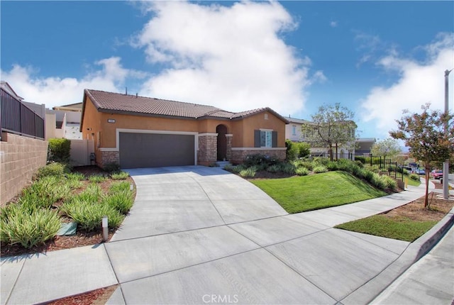 view of front of home featuring a garage and a front lawn