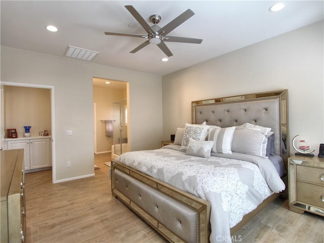 bedroom featuring light hardwood / wood-style flooring, ceiling fan, and ensuite bathroom