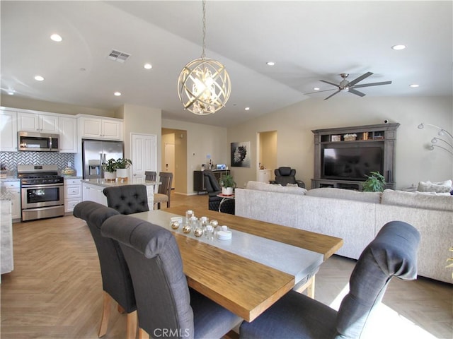 dining area featuring light parquet floors, lofted ceiling, and ceiling fan with notable chandelier