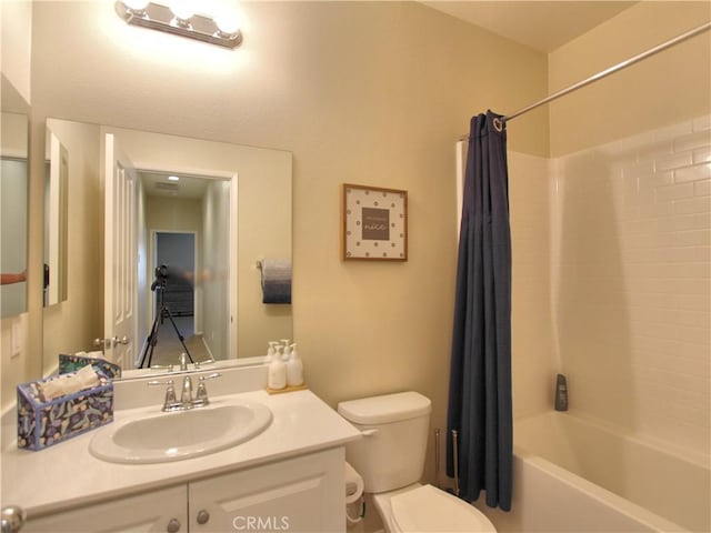 full bathroom featuring vanity, toilet, and shower / bath combo with shower curtain