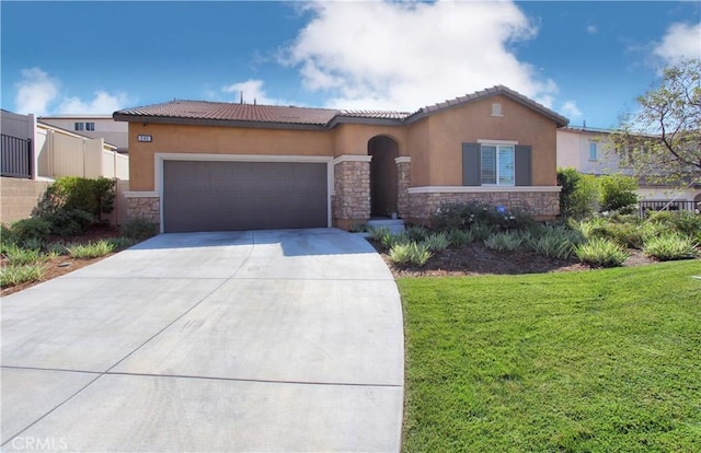 view of front of home featuring a garage and a front lawn