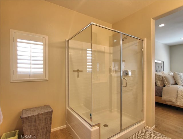 bathroom featuring an enclosed shower and hardwood / wood-style floors