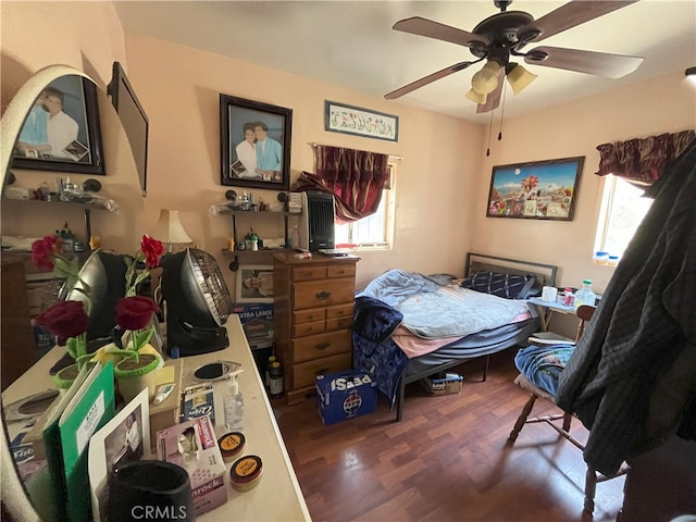 bedroom with ceiling fan and dark hardwood / wood-style flooring