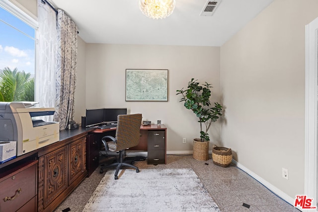 office space with an inviting chandelier