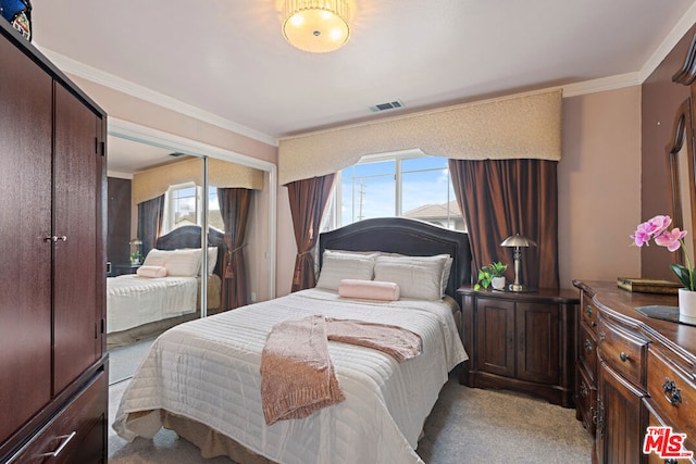 bedroom featuring ornamental molding, light colored carpet, and a closet