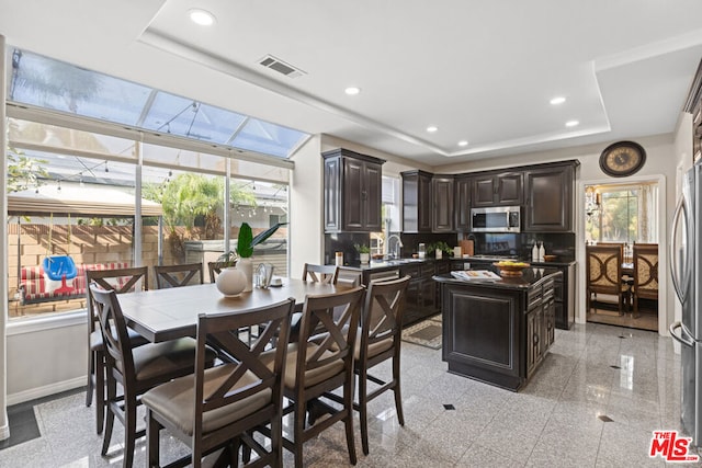 interior space featuring a tray ceiling and sink