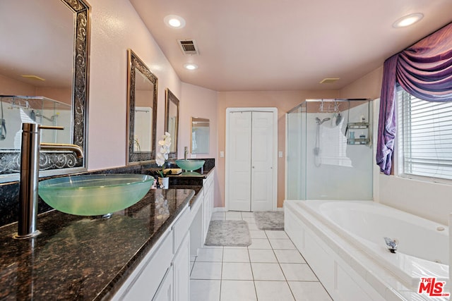 bathroom featuring tile patterned flooring, vanity, and shower with separate bathtub