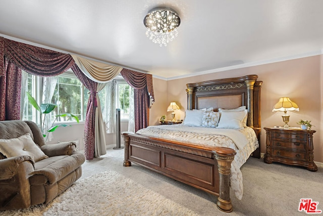 carpeted bedroom with ornamental molding and an inviting chandelier