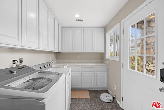 laundry room featuring sink, cabinets, and washing machine and clothes dryer