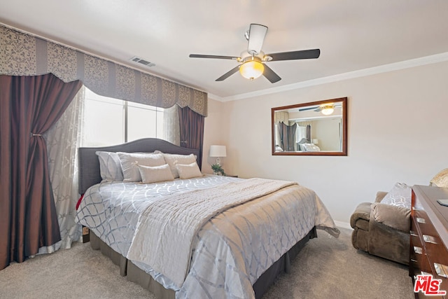 carpeted bedroom with crown molding and ceiling fan