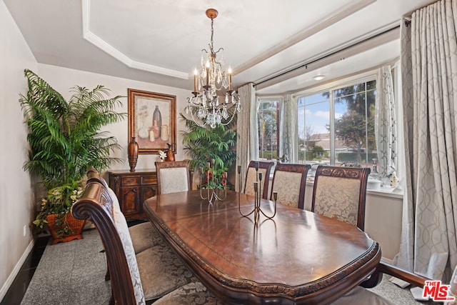 dining room with an inviting chandelier and a tray ceiling