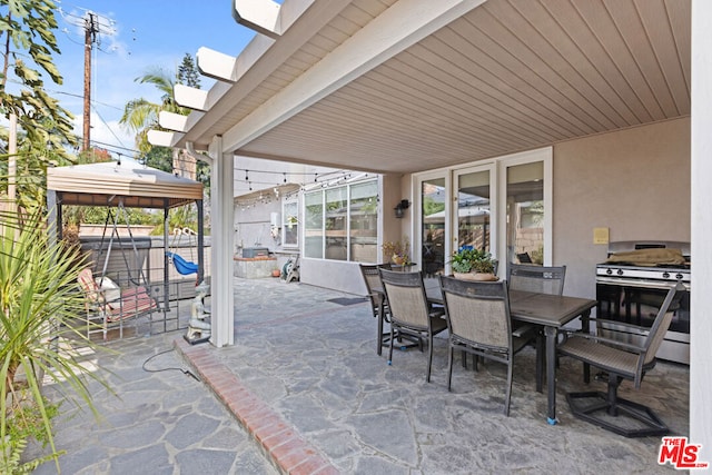 view of patio / terrace with a hot tub