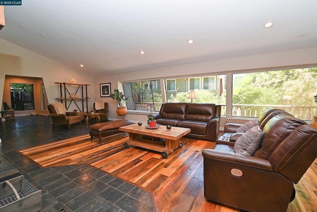 living room with hardwood / wood-style flooring and vaulted ceiling