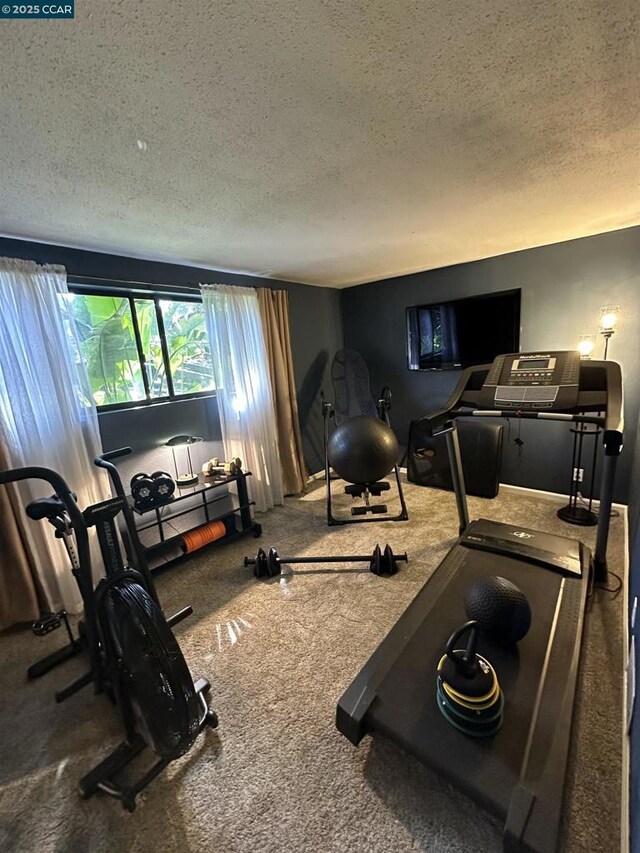 workout room with a textured ceiling