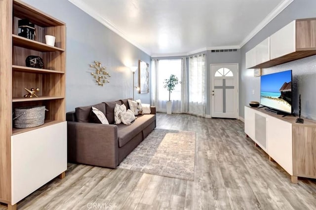 living room featuring ornamental molding and light hardwood / wood-style floors