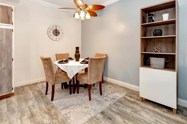 dining room featuring crown molding, ceiling fan, and hardwood / wood-style floors