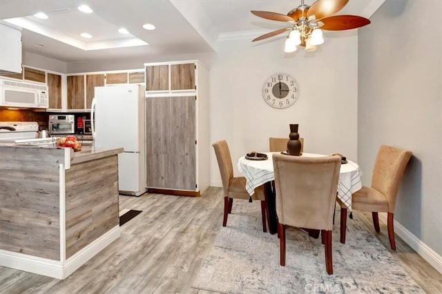 dining room featuring ceiling fan and light wood-type flooring