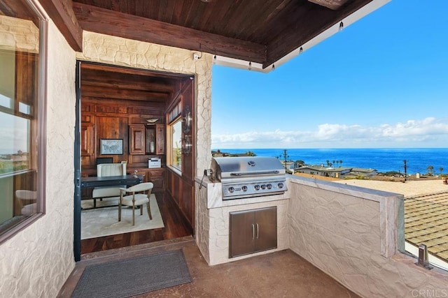 view of patio / terrace featuring area for grilling and a water view