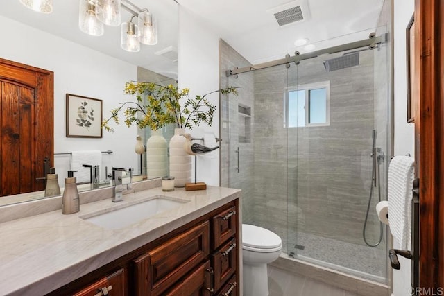 bathroom featuring vanity, an enclosed shower, and toilet