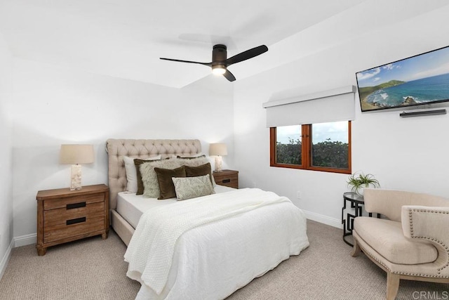 bedroom with ceiling fan and light carpet