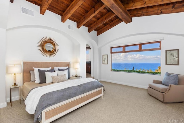 bedroom with a water view, wood ceiling, carpet, and vaulted ceiling with beams